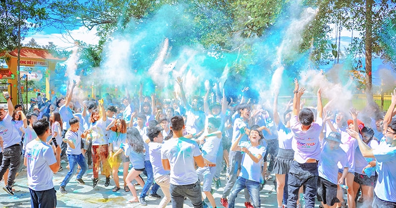 Summer camp event with children throwing coloured powder