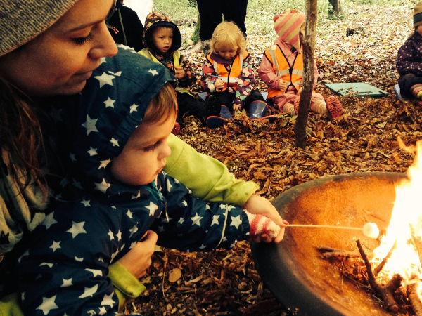 Child and Little Wild Things team member toasting marshmellows