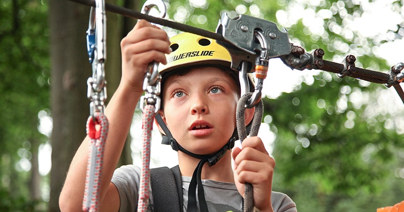 Child preparing for zipline activity